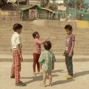 children playing hide and seek on ghats of Varanasi
